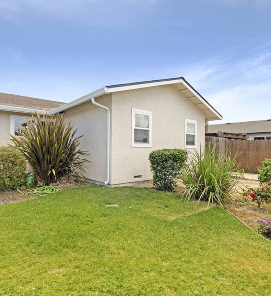 Home addition with grass and bushes